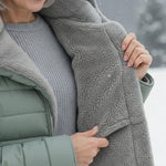 Woman wearing a fleece-lined quilted padded jacket with a shaped waist