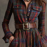 Woman wearing a belted plaid shirt dress with structured collar and flared skirt