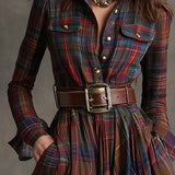 Woman wearing a belted plaid shirt dress with structured collar and flared skirt