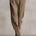 Woman wearing a tailored check jumpsuit with belt