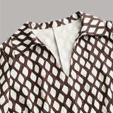 Woman wearing a rhombus print dress with belted waist