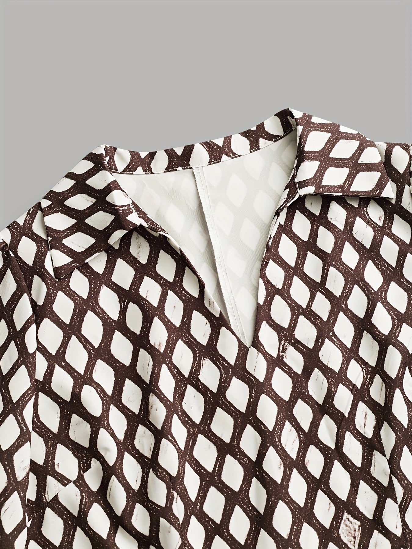 Woman wearing a rhombus print dress with belted waist