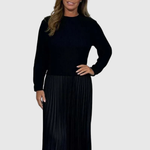 Woman wearing a maxi dress with a knit-look bodice and pleated skirt