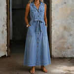 Woman wearing a long sleeveless denim shirt dress with button front