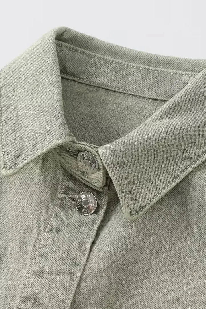 Woman wearing denim dungarees with a classic collar