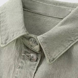 Woman wearing denim dungarees with a classic collar