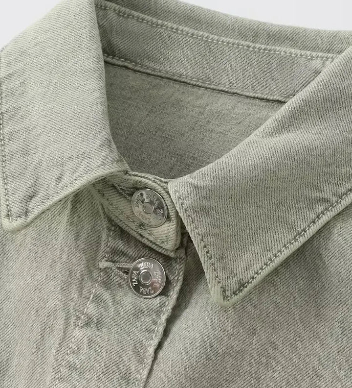 Woman wearing denim dungarees with a classic collar