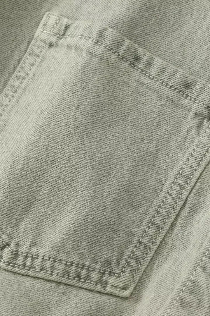 Woman wearing denim dungarees with a classic collar