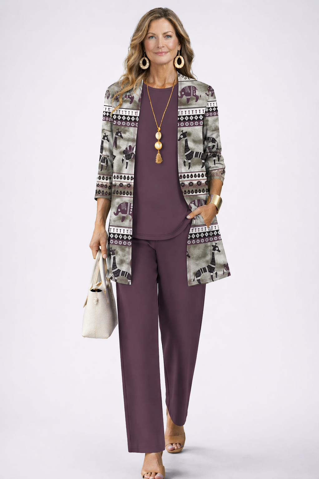 Woman wearing a dark mauve three-piece cardigan, top and trousers co-ord set