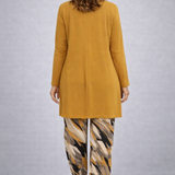 Woman wearing a yellow three-piece cardigan, top and trousers co-ord set