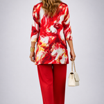 Woman wearing a red three-piece cardigan, top and trousers co-ord set