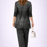 Woman wearing a black three-piece cardigan set with wide-leg trousers