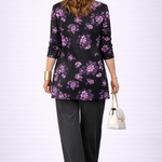 Woman wearing a purple and black three-piece cardigan, top and trousers co-ord set