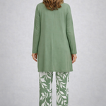 Woman wearing a green three-piece cardigan, top and trousers co-ord set