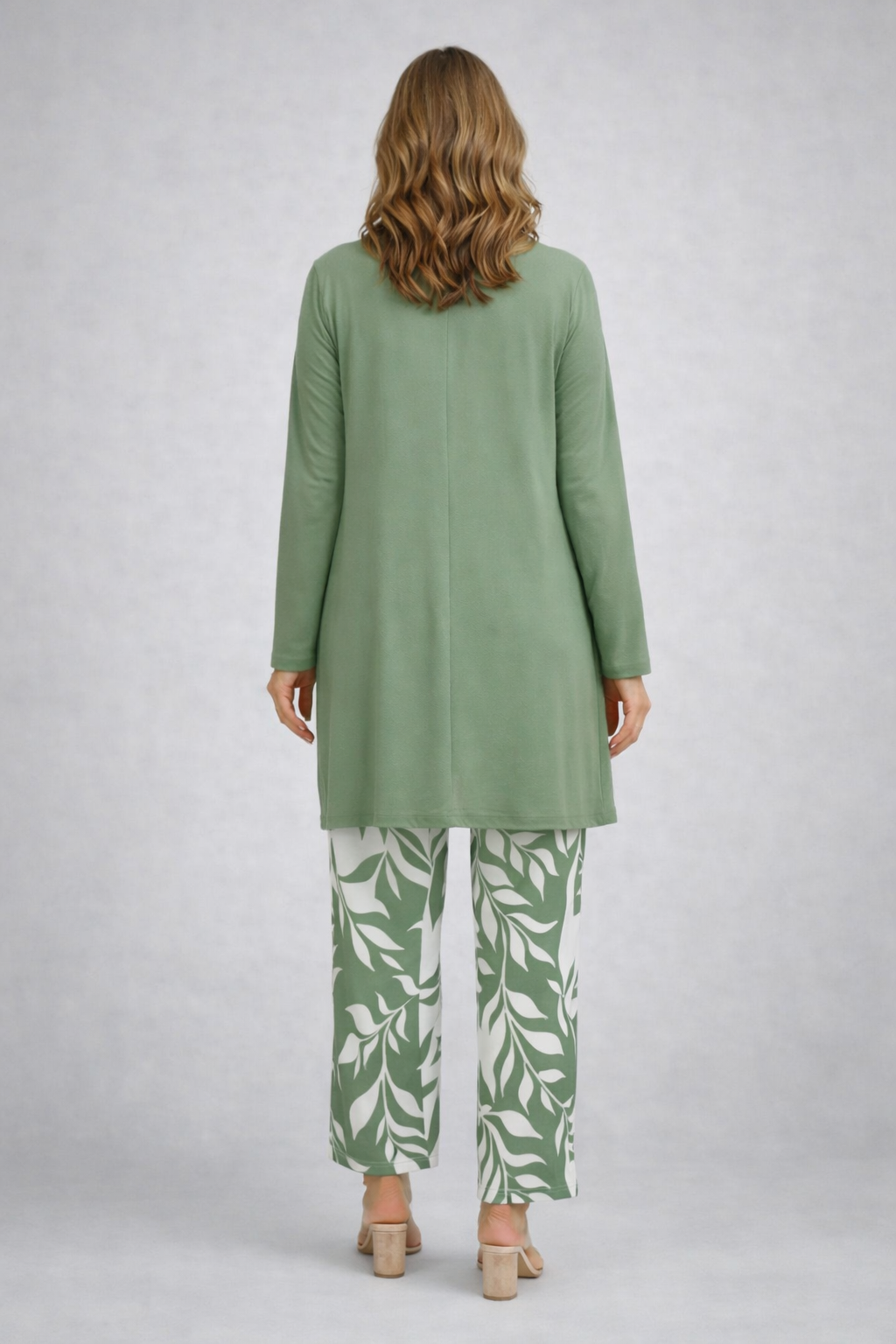 Woman wearing a green three-piece cardigan, top and trousers co-ord set