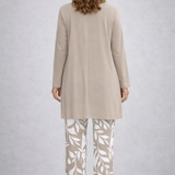 Woman wearing a cream three-piece cardigan, top and trousers co-ord set