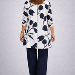 Woman wearing a blue and white three-piece cardigan, top and trousers co-ord set