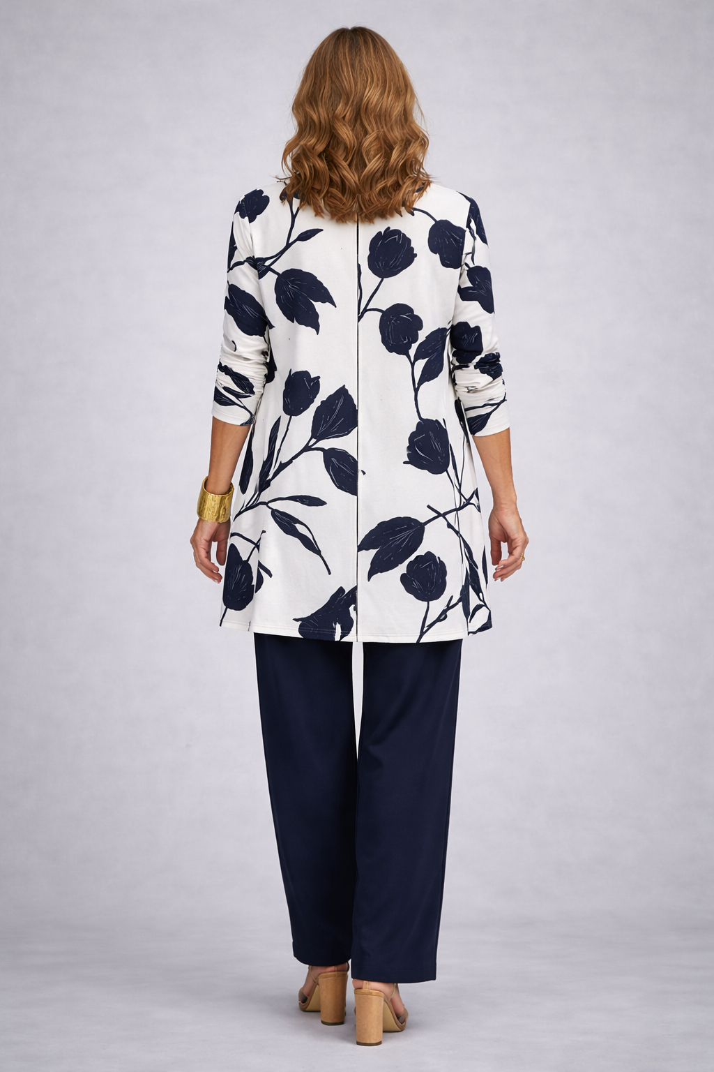 Woman wearing a blue and white three-piece cardigan, top and trousers co-ord set