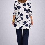 Woman wearing a blue and white three-piece cardigan, top and trousers co-ord set