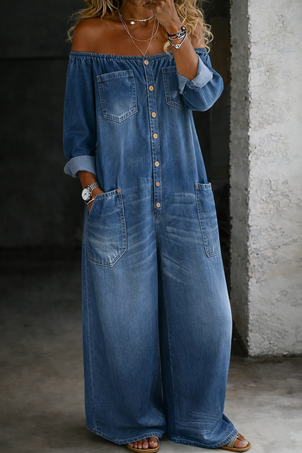 Woman wearing a long-sleeve off-shoulder denim jumpsuit
