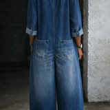 Woman wearing a long-sleeve off-shoulder denim jumpsuit