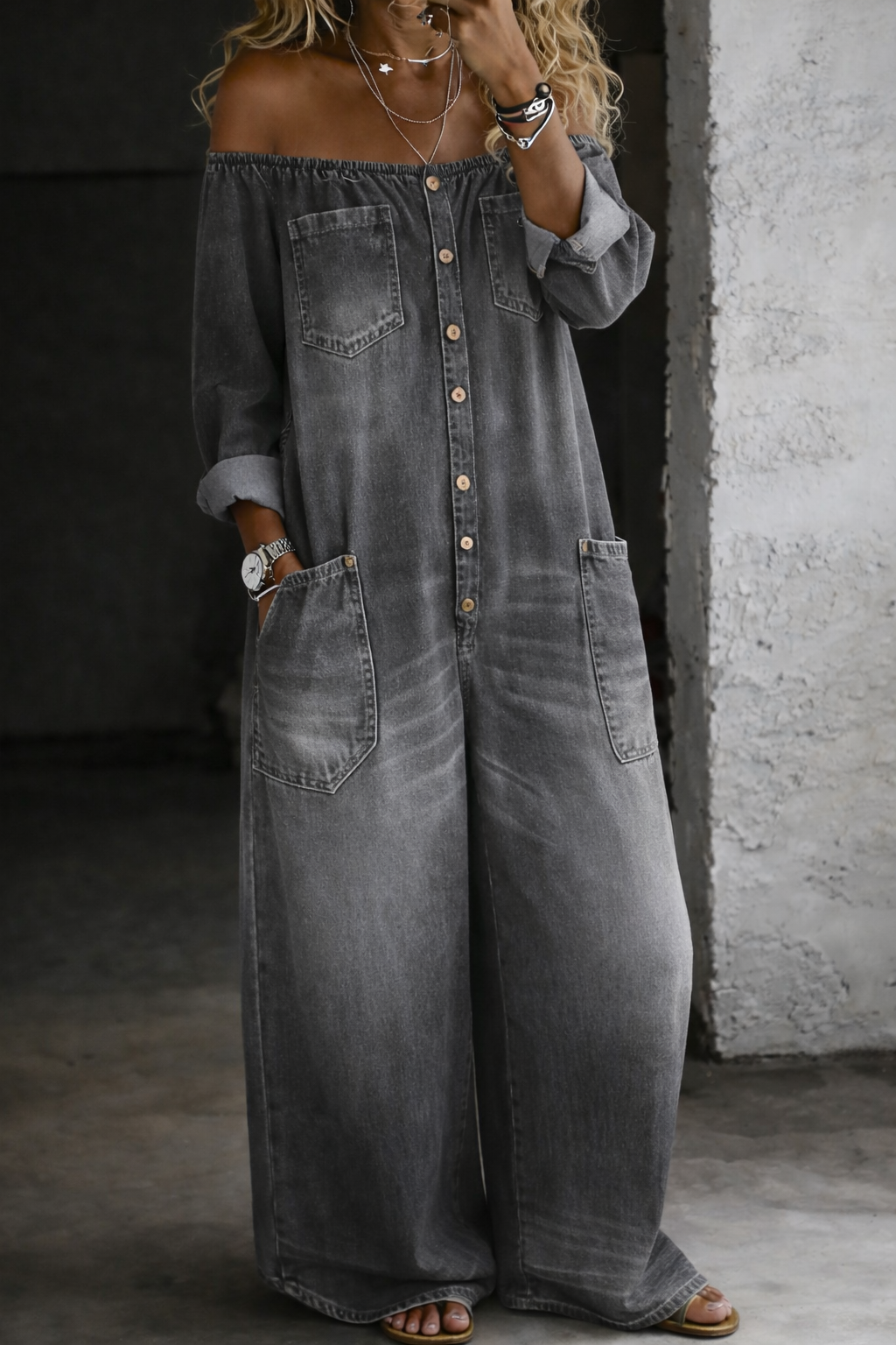 Woman wearing a long-sleeve off-shoulder denim jumpsuit
