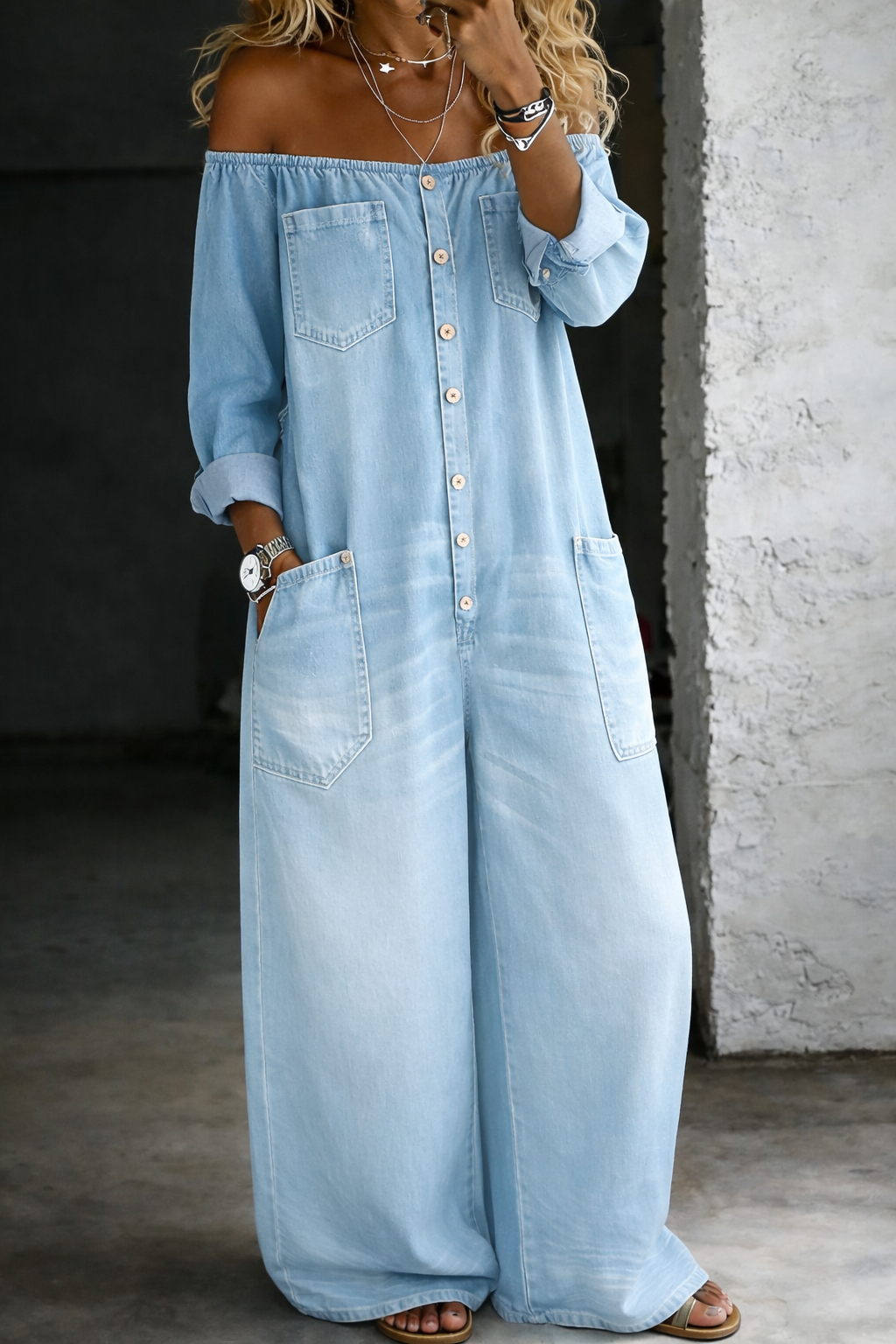 Woman wearing a long-sleeve off-shoulder denim jumpsuit