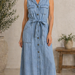 Woman wearing a long sleeveless denim shirt dress with button front