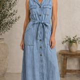 Woman wearing a long sleeveless denim shirt dress with button front