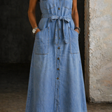 Woman wearing a long sleeveless denim shirt dress with button front