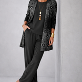 Woman wearing a black three-piece cardigan set with wide-leg trousers