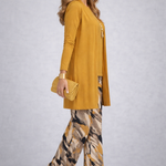 Woman wearing a yellow three-piece cardigan, top and trousers co-ord set