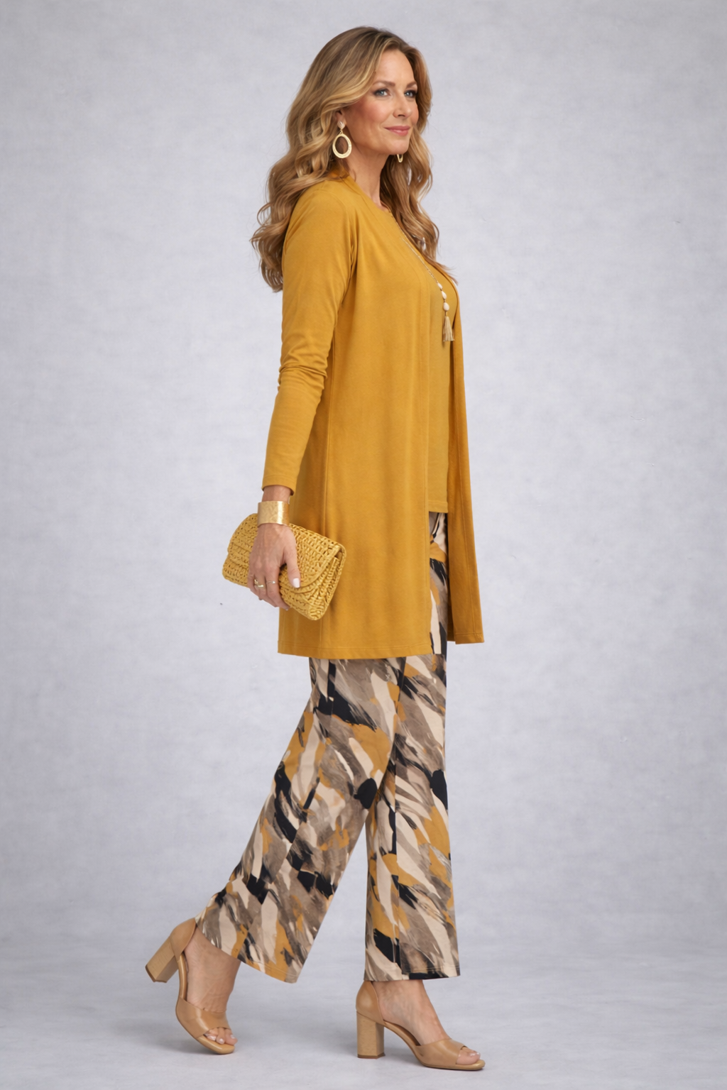 Woman wearing a yellow three-piece cardigan, top and trousers co-ord set