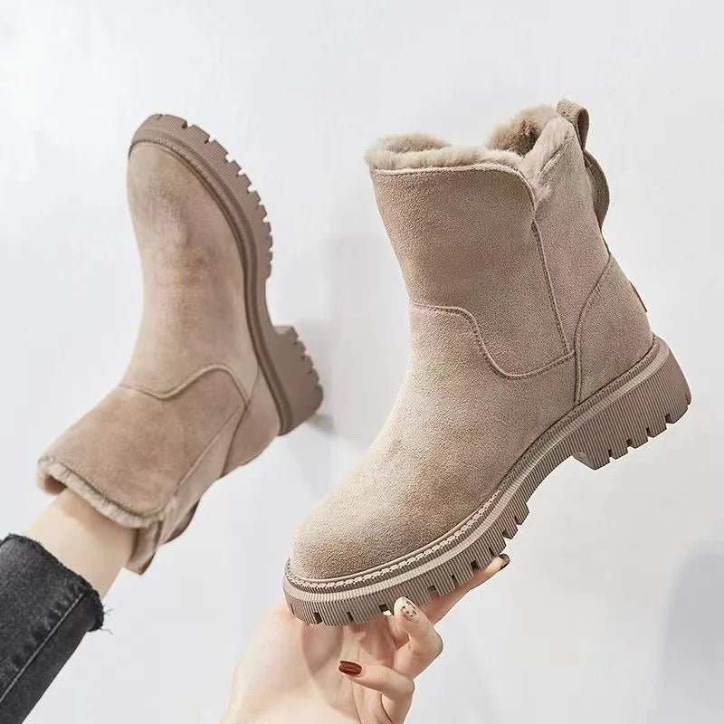 Nora Fur-Trimmed Suede Winter Boots in Apricot, held up to show sole tread