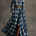Woman wearing a belted plaid shirt dress with structured collar and flared skirt