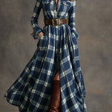 Woman wearing a belted plaid shirt dress with structured collar and flared skirt