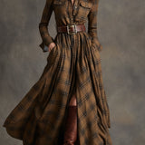 Woman wearing a belted plaid shirt dress with structured collar and flared skirt