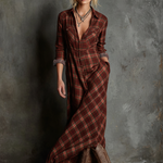 Woman wearing a full-length green plaid shirt dress with long sleeves