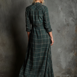 Woman wearing a full-length green plaid shirt dress with long sleeves