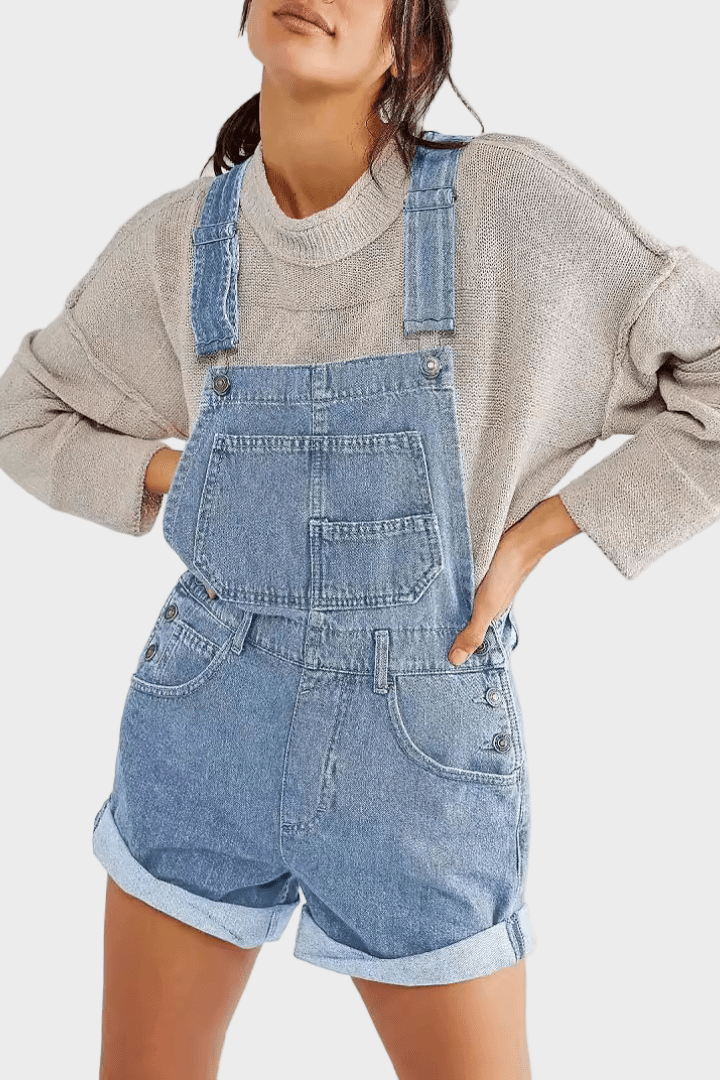 Woman wearing classic denim dungaree shorts with front pocket