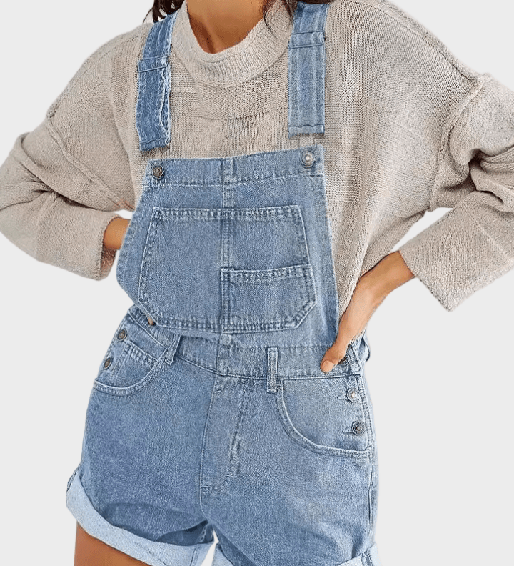 Woman wearing classic denim dungaree shorts with front pocket