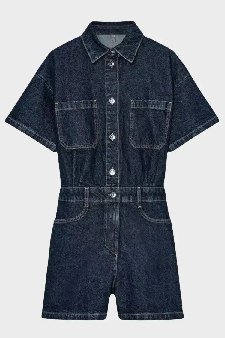 Woman wearing denim dungarees with front button fastening