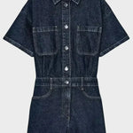 Woman wearing denim dungarees with front button fastening