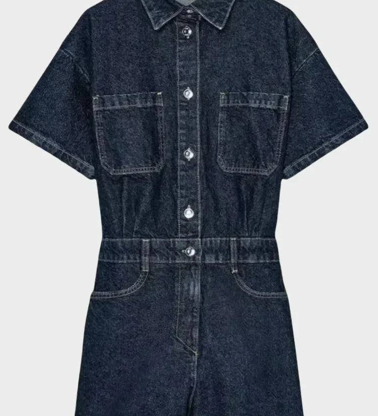 Woman wearing denim dungarees with front button fastening