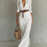 Woman wearing a wrap-style maxi dress with belt