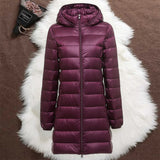 Woman wearing a purple long padded jacket