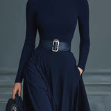 Woman wearing a high-neck A-line maxi dress