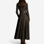 Woman wearing a belted vintage plaid maxi dress