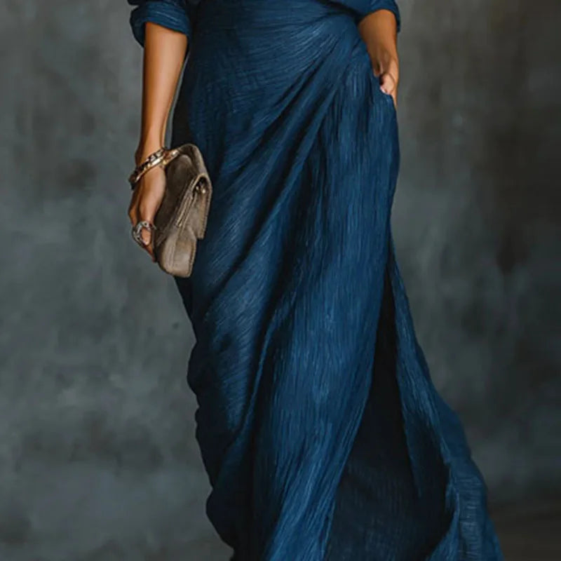 Woman wearing a pleated two-piece maxi skirt set