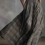 Woman wearing a vintage plaid shirt dress with full skirt
